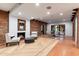 Elegant dining area with exposed brick, tile floor, and modern dining table at 3807 N 55Th Pl, Phoenix, AZ 85018
