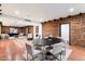 Modern dining room with exposed brick, round table, and comfortable chairs at 3807 N 55Th Pl, Phoenix, AZ 85018