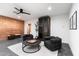 Basement game room with exposed brick wall and comfortable seating at 3807 N 55Th Pl, Phoenix, AZ 85018