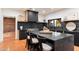 Modern kitchen with dark cabinetry, marble countertops, and a large island at 3807 N 55Th Pl, Phoenix, AZ 85018