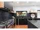 Modern kitchen with dark cabinetry, marble countertops, and a farmhouse sink at 3807 N 55Th Pl, Phoenix, AZ 85018