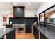 Modern kitchen with stainless steel appliances and dark marble countertops at 3807 N 55Th Pl, Phoenix, AZ 85018
