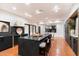 Modern kitchen with a large island, dark cabinetry, and terracotta tile floors at 3807 N 55Th Pl, Phoenix, AZ 85018