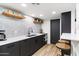 Modern kitchen with dark cabinetry and white countertops at 3807 N 55Th Pl, Phoenix, AZ 85018