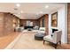 Spacious living room with exposed brick walls, comfortable seating, and modern decor at 3807 N 55Th Pl, Phoenix, AZ 85018