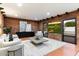 Living room with golf course view, exposed brick, and modern furnishings at 3807 N 55Th Pl, Phoenix, AZ 85018