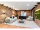 Living room with golf course view, exposed brick, and modern furnishings at 3807 N 55Th Pl, Phoenix, AZ 85018
