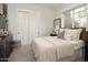 Spacious bedroom with plush bedding, built-in closet, and a window with natural light at 3851 N 50Th St, Phoenix, AZ 85018