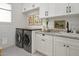 Bright laundry room with stacked washer/dryer, white cabinets, and granite countertop at 3851 N 50Th St, Phoenix, AZ 85018