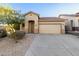 Tan house with a two-car garage and landscaping at 3929 W Glacier Ct, Anthem, AZ 85086