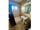 Clean bathroom with a pedestal sink and shower/tub combo at 5016 S 20Th Pl, Phoenix, AZ 85040