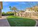 Landscaped backyard with artificial turf and paver patio at 5026 W Parsons Rd, Phoenix, AZ 85083