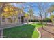 Artificial turf backyard with mature trees and a view of neighboring homes at 5026 W Parsons Rd, Phoenix, AZ 85083