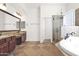 Spa-like bathroom with double vanity, soaking tub, and separate shower at 5026 W Parsons Rd, Phoenix, AZ 85083