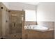 Bathroom with walk-in shower and a large soaking tub at 5026 W Parsons Rd, Phoenix, AZ 85083