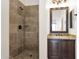 Bathroom with granite vanity, dark wood cabinets and a shower at 5026 W Parsons Rd, Phoenix, AZ 85083