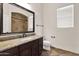 Bathroom with granite countertop, dark wood cabinets, and a shower with tile surround at 5026 W Parsons Rd, Phoenix, AZ 85083