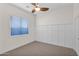 Bedroom with window, ceiling fan and wainscoting at 5026 W Parsons Rd, Phoenix, AZ 85083