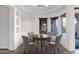 Bright dining area with a round table, four chairs, and natural light from surrounding windows at 5026 W Parsons Rd, Phoenix, AZ 85083