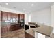 Modern kitchen with dark wood cabinets, granite countertops, and stainless steel appliances at 5026 W Parsons Rd, Phoenix, AZ 85083