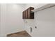 Laundry room with dark wood cabinets and a hanging rod at 5026 W Parsons Rd, Phoenix, AZ 85083