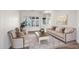 Elegant living room with stylish seating, large windows, and a neutral color palette at 5026 W Parsons Rd, Phoenix, AZ 85083
