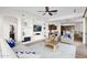 Open living room with built-in shelving, comfortable seating, and a ceiling fan at 5026 W Parsons Rd, Phoenix, AZ 85083
