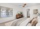Serene main bedroom featuring a window, dresser, and neutral color palette at 5026 W Parsons Rd, Phoenix, AZ 85083