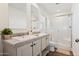 Modern bathroom with dual vanity and walk-in shower at 53259 W Barn Owl Rd, Maricopa, AZ 85139