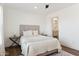 Light and airy bedroom with a comfortable bed and access to bathroom at 53259 W Barn Owl Rd, Maricopa, AZ 85139