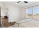 Bright bedroom with large windows and view of backyard at 53259 W Barn Owl Rd, Maricopa, AZ 85139
