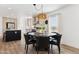 Kitchen features a round dining table with six black chairs at 53259 W Barn Owl Rd, Maricopa, AZ 85139