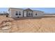 Single story home with neutral color scheme and desert landscaping at 53259 W Barn Owl Rd, Maricopa, AZ 85139