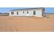 New manufactured home with a paved patio and spacious desert lot at 53259 W Barn Owl Rd, Maricopa, AZ 85139