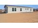Tan colored house with patio and yard at 53259 W Barn Owl Rd, Maricopa, AZ 85139