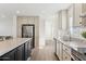 Open concept kitchen with island, stainless steel appliances and light cabinets at 53259 W Barn Owl Rd, Maricopa, AZ 85139