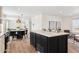 Modern kitchen with island, dining area, and stainless steel appliances at 53259 W Barn Owl Rd, Maricopa, AZ 85139