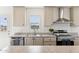 Modern kitchen features stainless steel appliances and light beige cabinets at 53259 W Barn Owl Rd, Maricopa, AZ 85139