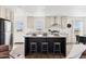 Modern kitchen with island, stainless steel appliances, and marble countertops at 53259 W Barn Owl Rd, Maricopa, AZ 85139