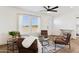 Bright living room with four brown armchairs and a glass coffee table at 53259 W Barn Owl Rd, Maricopa, AZ 85139