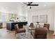 Open living area with leather armchairs, coffee table, and kitchen view at 53259 W Barn Owl Rd, Maricopa, AZ 85139