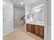 Clean bathroom with double sinks, large mirrors, and a walk-in shower at 5341 E Carol Ave, Mesa, AZ 85206