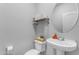 Small bathroom with pedestal sink and toilet at 5341 E Carol Ave, Mesa, AZ 85206