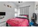Bright bedroom with a pink comforter and window at 5341 E Carol Ave, Mesa, AZ 85206