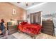 Bedroom with red comforter and brick wall at 5341 E Carol Ave, Mesa, AZ 85206