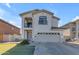 Two-story house with balcony, attached garage, and landscaping at 5341 E Carol Ave, Mesa, AZ 85206