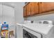 Laundry room with washer, dryer, and cabinets at 5341 E Carol Ave, Mesa, AZ 85206