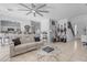 Open living room with a comfortable couch, a game table, and views of the kitchen at 5341 E Carol Ave, Mesa, AZ 85206