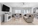 Relaxing living room with beige couches, a modern coffee table, and a large TV at 5341 E Carol Ave, Mesa, AZ 85206