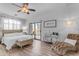 Spacious main bedroom with a king-size bed, a chaise lounge, and large windows at 5341 E Carol Ave, Mesa, AZ 85206